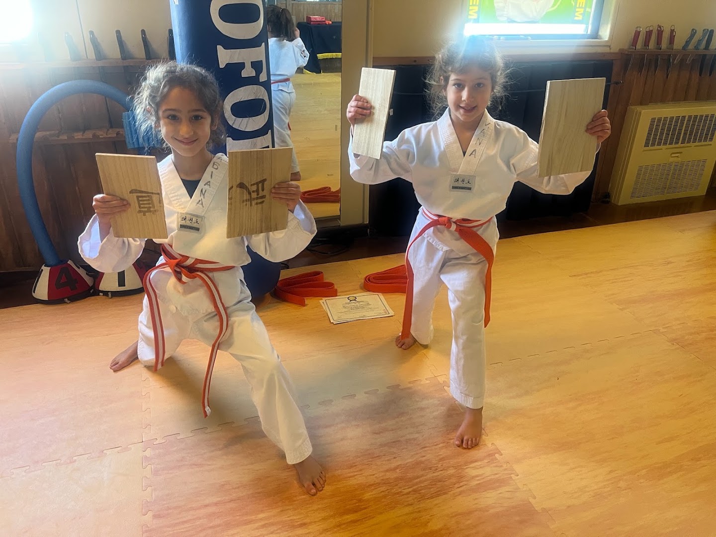 Two students holding up their broken boards